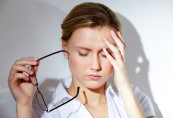 Portrait of young businesswoman having headache pains